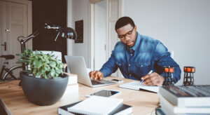 Afro american young man working at home office