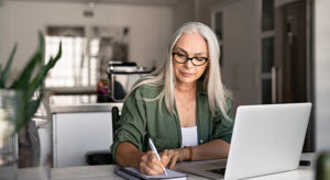 Senior fashionable woman working at home