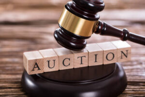 Close-up Of A Gavel Striking On Auction Word
